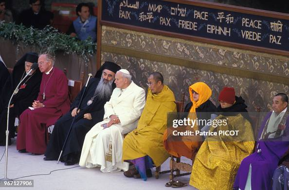 mariaebyrd's tweet photo. Buckle-up. Today the novus ordo counter church celebrates the apostasy of JP II, and idol worship will abound.

Stop drinking the poisonous, novus ordo counter church Kool-Aid!

See list below for a small sampling of his apostasy:

Interreligious Ecumenism & Assisi Meetings: The 1986 World Day of Prayer for Peace in Assisi, where leaders of various non-Christian religions gathered to pray, was a violation of the First Commandment and a promotion of religious indifferentism or syncretism.

Kissing the Quran: His public gesture of kissing the Quran in 1999 during a meeting with Iraqi delegates denied the divinity of Jesus Christ.

Judaism and "Elder Brothers: He referred to Jews as "our elder brothers in the faith" and suggested that Jewish covenants and expectations of the Messiah were not in vain, which negated the necessity of conversion to Christianity.

Religious Freedom (Dignitatis Humanae):  John Paul II endorsed the false notion that error has a "right" to public expression", contradicting past papal encyclicals like Syllabus Errorum or Pascendi.

Universal Salvation Accusations: His writings (such as Redemptor Hominis) implied an unbreakable union between Christ and every human being that borders on universalism (the idea that all people are automatically saved).

Collegiality and Governance: His emphasis on episcopal collegiality and ecumenical outreach undermined traditional Papal supremacy and the exclusive claim of the Catholic Church as the sole ark of salvation.

Sancta Maria, Mater Dei, Mater Ecclesiae, ora pro nobis!

Image: "Pope" John Paul II surrounded by representatives of various religions including the Dalai Lama during interreligious meetings on October 27, 1986 in Assisi, Italy.