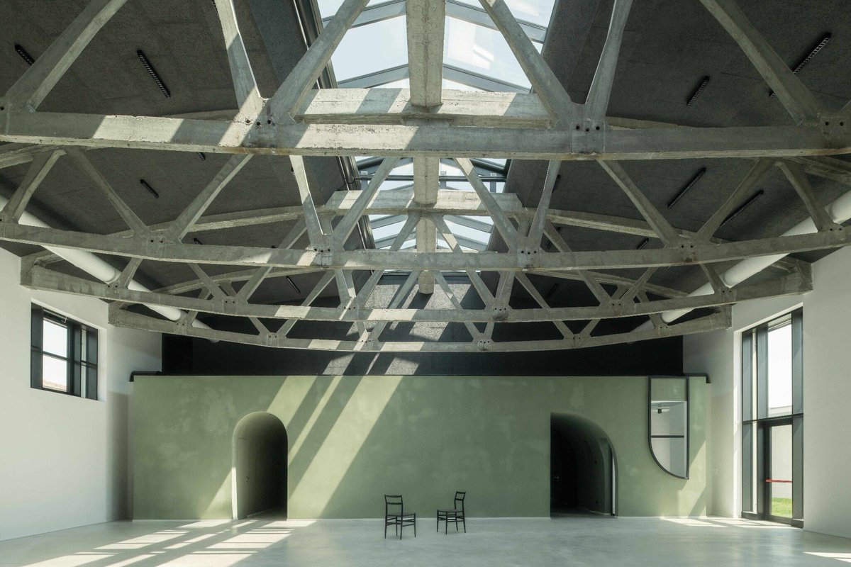 Archello's tweet photo. Exposed concrete and visible structural elements preserve the industrial character of Treviso’s former slaughterhouse, now reimagined by TIXA studio associato as a day centre for people in vulnerable circumstances. 
https://t.co/O4ENAk0h3j 

#AdaptiveReuse #IndustrialHeritage https://t.co/CDkIYTyhf1