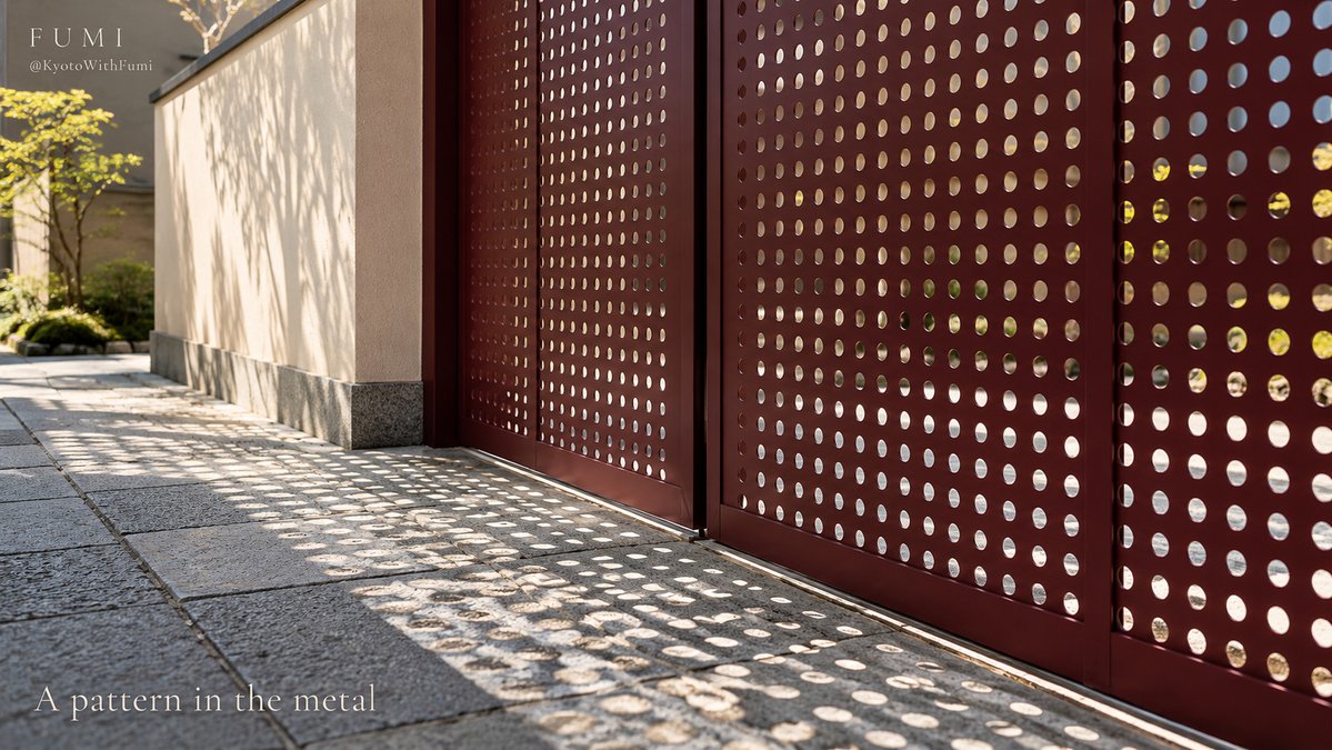 KyotoWithFumi's tweet photo. ✳

A perforated metal gate can make a Kyoto lane feel unexpectedly modern.

Look at the circles, the shadow and the glimpse of daylight beyond. The pleasure is in finding a new pattern beside the textures you thought you had come to see.

#FumiJapan https://t.co/PDWhILLE21