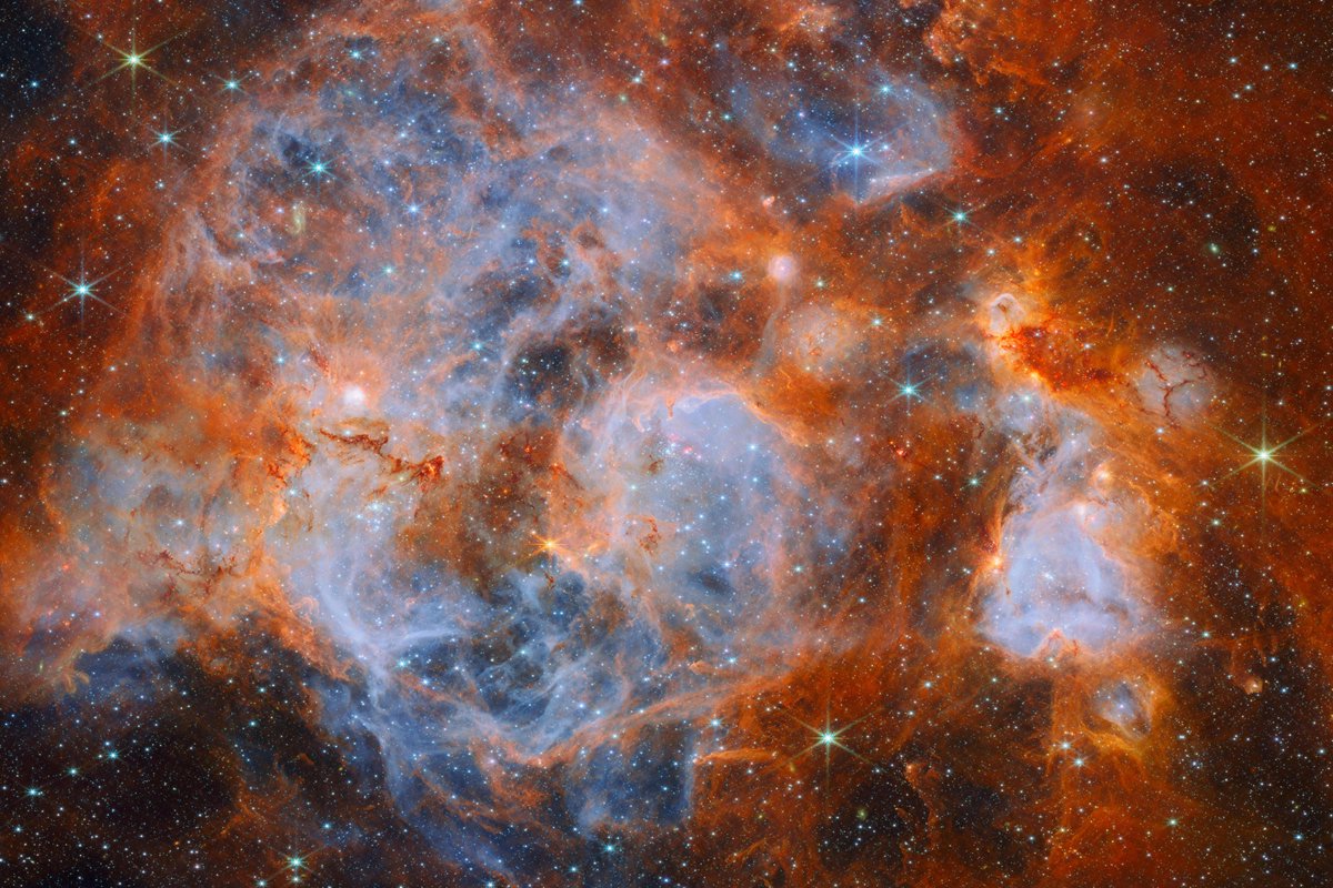 NASAWebb's tweet photo. Double, double toil and trouble; Fire burn and cauldron bubble ��‍♀️

This turbulent cauldron of star formation, N159, resides about 161,000 light years away in the Large Magellanic Cloud, one of the satellite galaxies orbiting our Milky Way. 

https://t.co/qJTDi5noN0 https://t.co/JH3SUy6VVk