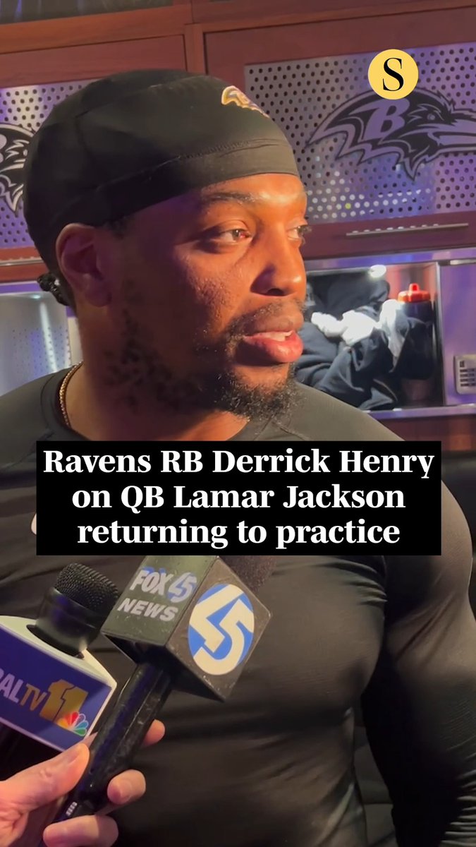 Baltimore Ravens running back Derrick Henry speaks to reporters; visible text reads “Ravens RB Derrick Henry on QB Lamar Jackson returning to practice,” with FOX 5 and WALT TV 11 microphones in view.