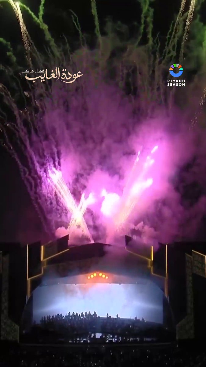 A nighttime Riyadh Season stage event features bright pink and white pyrotechnics, smoke, and a crowd, with Arabic text “عودة الغ vehicular شارع” and the “RIYADH SEASON” logo visible.