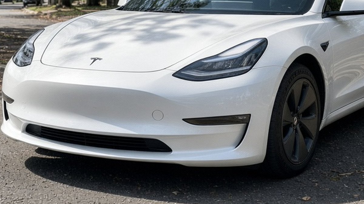 Cardabra_AI's tweet photo. We faked this car photo on purpose. It looks fine at a glance.

1. The shop sign is gibberish. AI still can't spell.
2. Zoom into the wheel. That centre cap isn't a Tesla logo.
3. No plate on the front at all.

Spot any other tells? Tell us in the replies. https://t.co/PlvbOinO1j