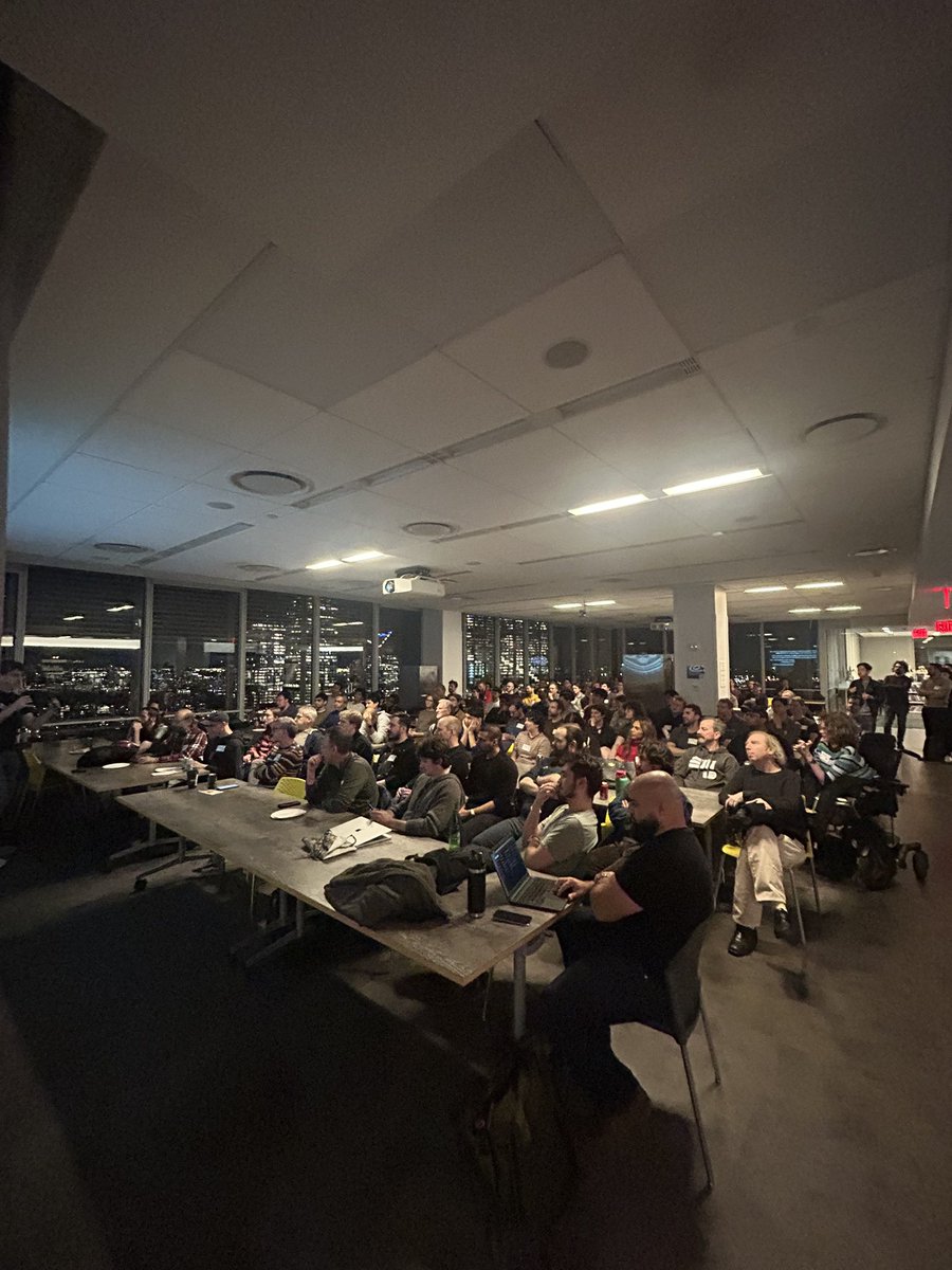 RossTheRustGuy's tweet photo. Rust NYC with @bcantrill is live, we just announced our UnConf to over 250 engineers, and there’s so many people here I can’t fit them all in a photo from any angle. Great night! https://t.co/N59tAD3QFq
