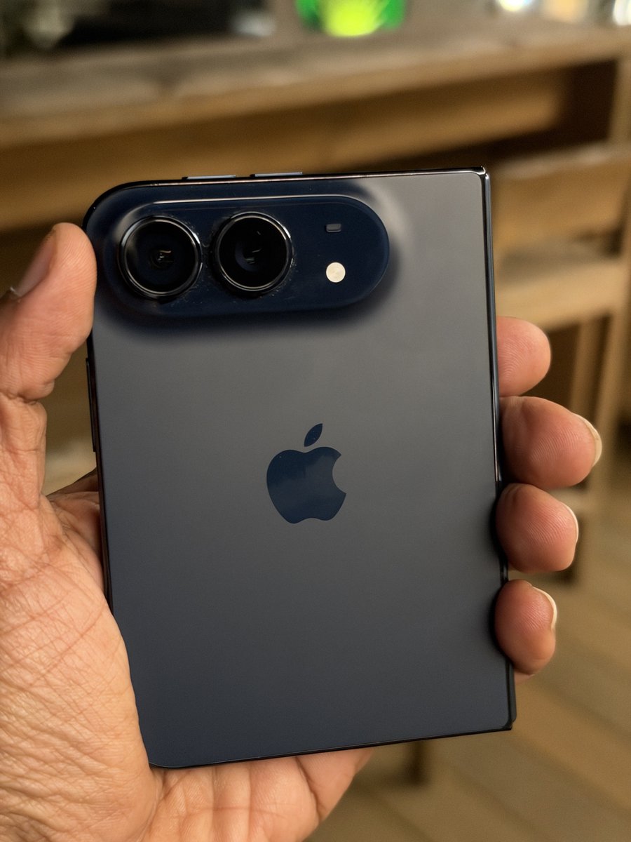 nirave's tweet photo. Happy iPhone Duo day! Mine is not arriving today (thanks to the incompetent folks at @ee) but I saw it yday and damn, I really like this form factor and hardware!

Also the Nano texture display is really nice, a different take on the crease but a good one! More thoughts soon! https://t.co/vkZzZ463BA