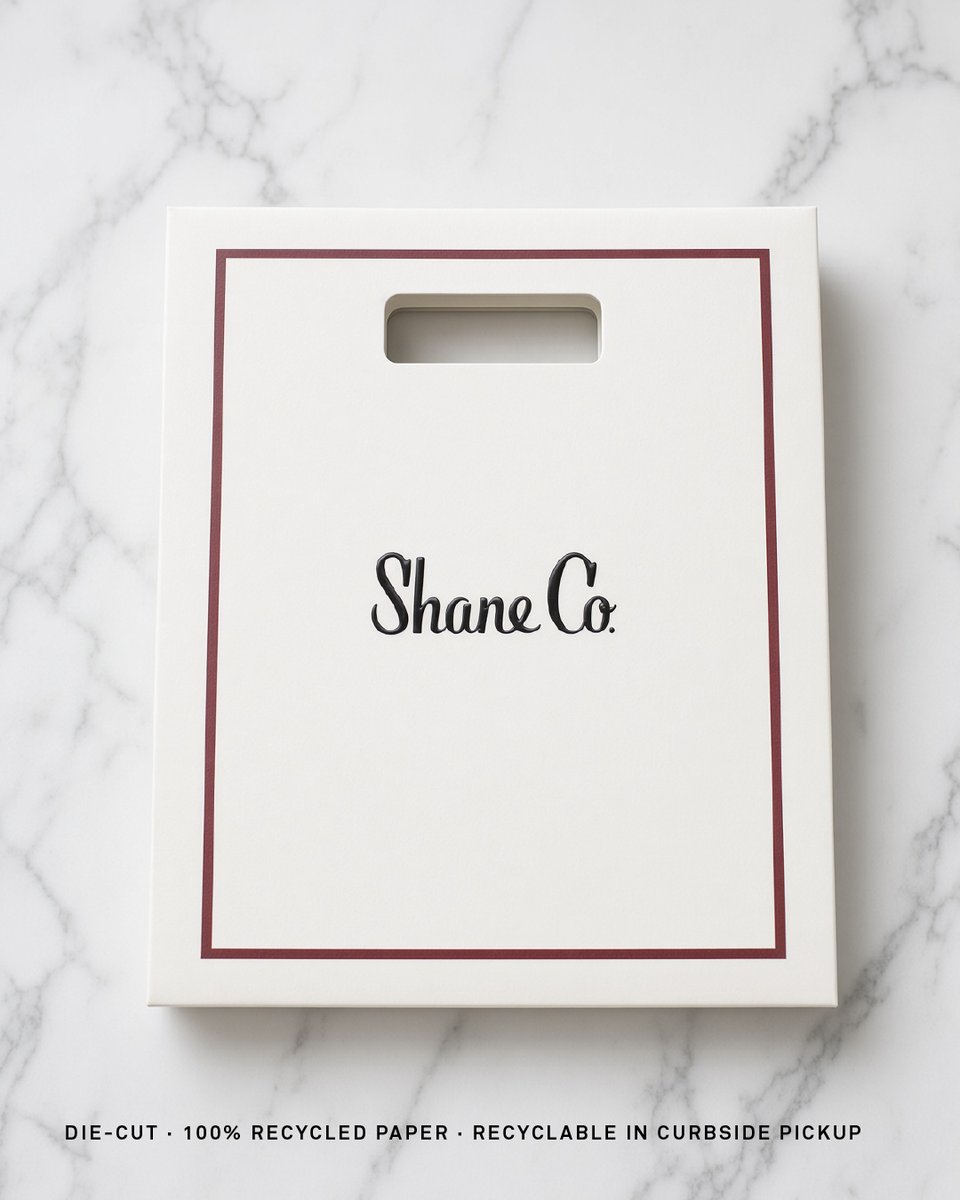 KargoPackaging's tweet photo. Shane Co wanted one shopping bag. We made two: the classic with a burgundy key line and satin ribbon for most US stores, and a die-cut bag in 100% recycled paper for Colorado. We sampled RPET ribbon, paper cord and flat weave handles to get there. #RetailPackaging https://t.co/aVWyVnZ8sP