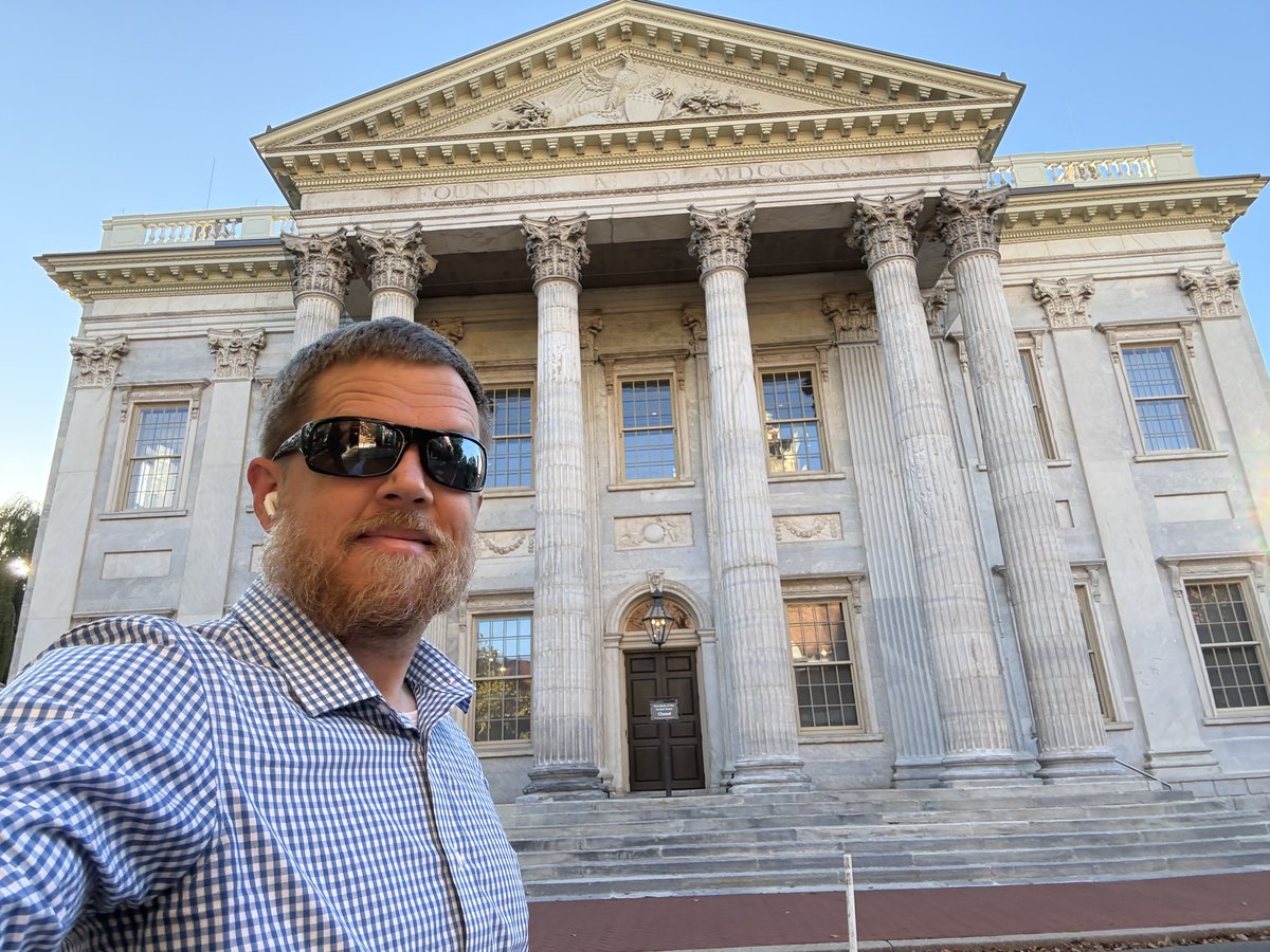 cboyack's tweet photo. Before the Federal Reserve, there was Alexander Hamilton’s First Bank of the United States, seen here during my walk through Philadelphia this morning. 

In 1790, Hamilton got the feds to take over every state’s war debt. His banker friends had already scooped up that debt for pennies, and taxpayers paid them back at full price. 

It was a massive wealth transfer from farming taxpayers to the banking elite.

The following year, Congress chartered the First Bank, modeling it on the Bank of England. Private investors owned 80% of it. 

Jefferson and Madison pointed out the obvious: the Constitution doesn't give Congress the power to charter a bank. A bank, however convenient, was not "necessary or proper" to exercising the enumerated powers: the government could obviously collect taxes and borrow money without creating one.

Hamilton replied that this interpretation effectively inserted words the Constitution did not contain—“absolutely” or “indispensably”—before “necessary.” 

Hamilton argued that the Necessary and Proper Clause gave “an explicit sanction to the doctrine of implied powers.”

Implied powers. Not what the Constitution's drafters actually agreed to. What they, ahem, implied.

In 1811, the bank’s charter expired. Americans were free of the banking elite for all of five years. The War of 1812 nearly tripled the debt, and Madison, who once called the bank unconstitutional, signed a Second Bank into law. (Principles get flexible fast when government needs cash…)

Andrew Jackson’s supporters called that Second Bank “the Monster,” and in 1832 Old Hickory vetoed its recharter. 

Within a few years, the national debt hit zero, the only time in American history. Coincidence? You decide.

Then the monster's descendant, the Creature from Jekyll Island, was born in 1913. The bankers struck back, and thus time secured permanent creation of a central bank—no expiration. Hamilton’s dream apparently just needed a century and a better PR team. 

I should point out that Hamilton's Broadway musical skips this part of history. @tuttletwins doesn’t. Our latest history book talks all about it. Link below.