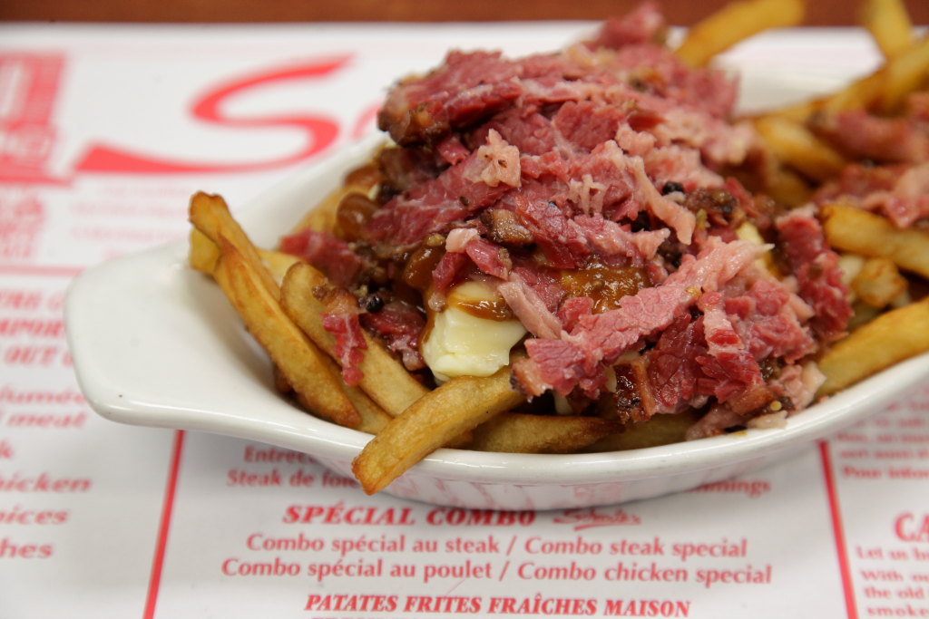 EIT's tweet photo. Poutine à la Schwartz's, topped with smoked-meat trimmings, and several hand-painted murals a short walk from Schwartz's Deli, Montreal https://t.co/zSEcAIahbv