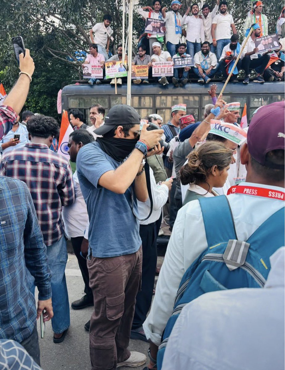 Politicx2029's tweet photo. Raihan Vadra is just 26 years old. 

He is the grandson of former Prime Minister Indira Gandhi, the son of Priyanka Gandhi Vadra, and the nephew of Rahul Gandhi. 

Yet he is out here capturing photographs at the Jantar Mantar protest site alongside ordinary people. 

No VIP attitude. No unnecessary show off. Just a young man following his passion for photography.

His family legacy is historic, but he is building his own identity through his work.

Meanwhile, BJP IT Cell and Godi media are questioning his presence at the protest. GODI MEDIA, PLEASE TAKE A LOOK AT THIS! 

THE LEGACY IS HUGE, BUT THE SIMPLICITY IS WHAT MAKES THIS MAN SO SPECIAL🫶🏻❤️

@raihanrvadra