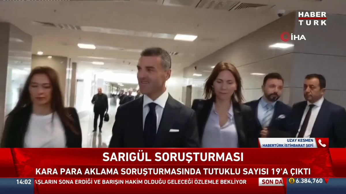 A Haber Türk/İHA news broadcast shows formally dressed officials walking through a building, with the chyron reading “SARIGÜL SORUŞTURMASI” and “KARA PARA AKLAMA SORUŞTURMASINDA TUTUKLU SAYISI 19’A ÇIKTI.” The image relates to the money-laundering investigation, though the accompanying post says 12 of the 14 people with arrest warrants have been apprehended; the visible ticker also shows “UZAY KESMEN – HABERTÜRK İSTİHBARAT ŞEFİ.”