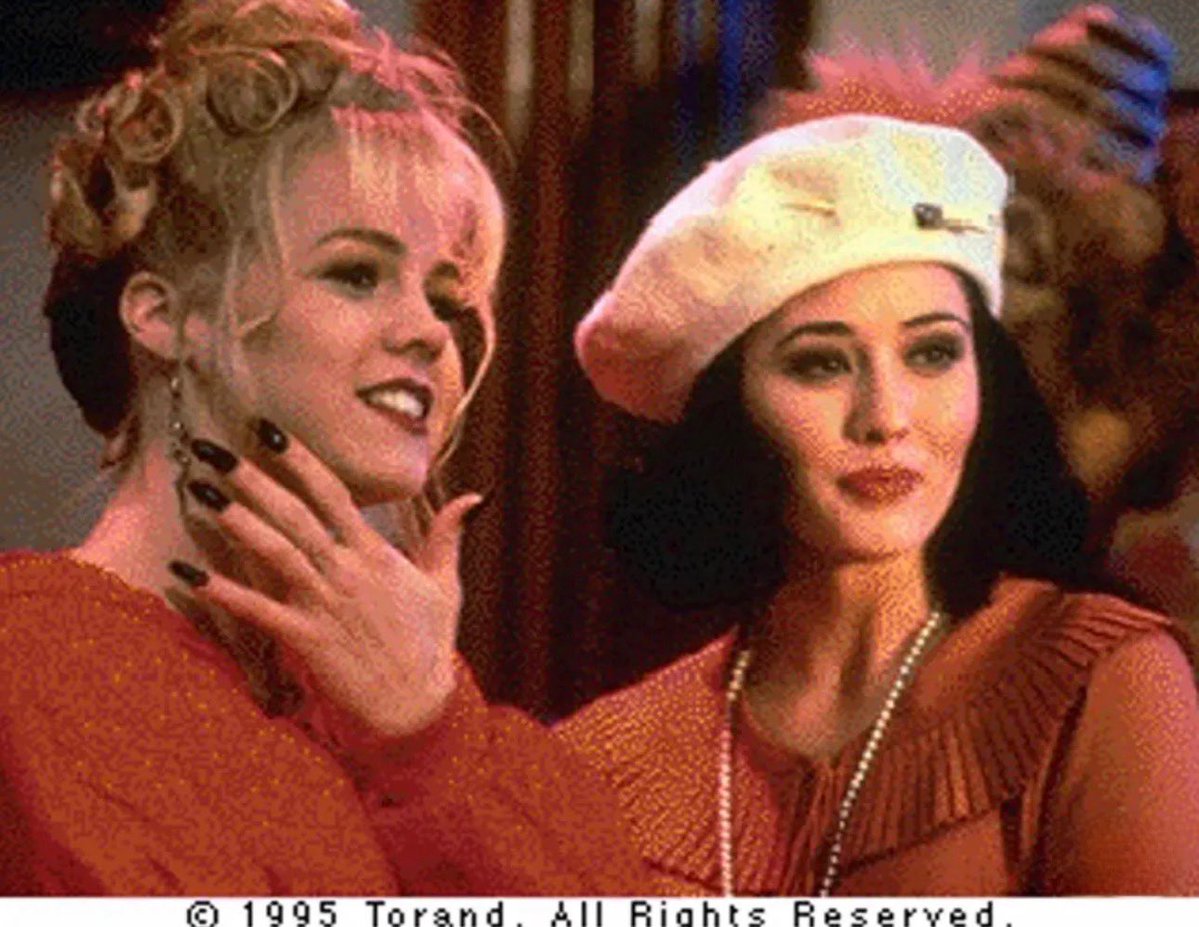 rewatching90210's tweet photo. The 1995 Beverly Hills 90210 CD-ROM contains a rare photo of Kelly wearing a red sweater over her sexy witch costume — an alternate look that never appeared in the actual episode https://t.co/LWRRvMUM6M