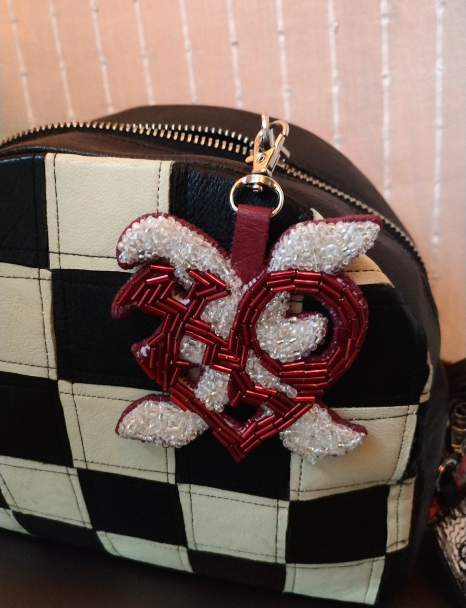 genevlov's tweet photo. Finished right before the I,God era ends 😭 Bead embroidered XLOV ✖️❤️ bag charm based on their brooch design. 
Actually fits perfectly with my checkered bag ♟️ https://t.co/GPRfUtUVjX
