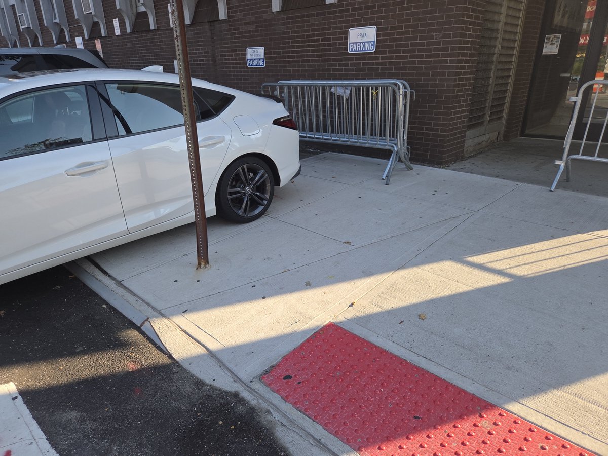 placardabuse's tweet photo. Apparently the @NYPD50Pct wasn't sure if their illegal sidewalk parking completely blocked wheelchair access on the sidewalk, so they piled some barricades there just to make sure.

Constant @CivilRights violations at this Americans with Disabilities "designated hub location." https://t.co/VaSGUSNQNc