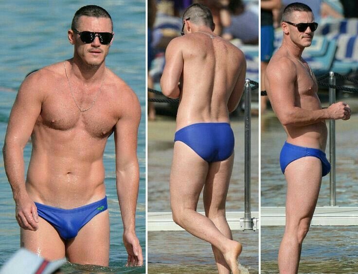 Paparazicentral's tweet photo. Welsh actor Luke Evans wearing blue swim briefs at the beach https://t.co/P6cUi3ImNu