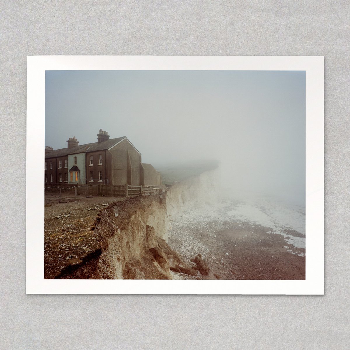KylacyStuartZin's tweet photo. Birling Gap, Collapsed Cliff, East Sussex © Alex Currie. A fog-bound row of coastguard cottages, one window lit, as the chalk cliff falls away beneath the fence line. Edition of 10. Comment SWAP for details. https://t.co/UeLegHKoW4