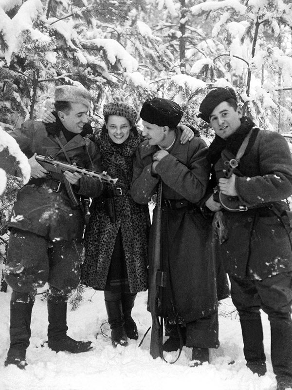 Vanguard_WW2's tweet photo. The Germans made her develop photographs of her family’s murder.

She secretly kept copies.

On August 14, 1942, German forces massacred 1,850 Jews from the ghetto of Lenin, in present-day Belarus—including Faye Schulman’s parents, sisters, and younger brother.

Faye was among just 26 people spared. Her photography skills made her useful to the killers.

When ordered to develop their photographs of the massacre, she secretly made an extra set—preserving evidence of the crime.

She later escaped during a partisan raid and joined a Soviet partisan unit in the forest. With no medical experience, she became a nurse. Their doctor had been a veterinarian; their operating table was made from tree branches.

During another raid, she recovered her photographic equipment.

She developed negatives beneath blankets, printed photographs using sunlight, and buried her camera before missions to keep it safe.

One photograph shows her smiling beside three Jewish friends. Each had believed the others dead. Amid the fighting—and antisemitism within her own unit—their reunion offered a rare moment of relief.

More than a hundred photographs preserved her world: wounded comrades, forest camps, funerals, friendship.

“I was a photographer. I have pictures. I have proof.”

Faye settled in Canada after the war. She died on April 24, 2021, aged 101. Her photographs still bear witness.

Follow @Vanguard_WW2 for more extraordinary lives behind the history of World War II.