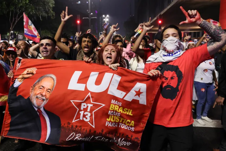 agent_of_change's tweet photo. Lula has won. What a joy, what a relief, what a stunning victory!

The stakes were extremely high. 

For Brazil’s democracy: Flávio Bolsonaro promised to rewrite the 1988 Constitution, overhaul the judiciary and go after the Supreme Court that convicted his father.

For Brazil’s working class: a Bolsonaro government would mean austerity, deregulation and an attack on the gains of the last four years, from Brazil’s exit from the UN Hunger Map to the abolition of the six-day working week.

For the planet: under Lula, Amazon deforestation has more than halved. Bolsonaro promised agribusiness and mining a free hand.

For Latin America: seven far-right candidates have won presidential elections in the region in 18 months, with the overt backing of Washington. Brazil would have been the biggest prize yet for the Donroe Doctrine.

For the world: Brazil is a founding member of BRICS, a consistent voice for peace and multipolarity, and an opponent of genocide in Gaza. A Bolsonaro government would have signed up to Trump’s Shield of the Americas, and aligned Brazil with the US and Israel against Palestine, Iran, Russia, China and the Global South.

What turned things around between the first and second rounds? More than anything: mass mobilisation. The left went into the streets and fought. Trade unions, students, social movements and oppressed groups mobilised on a scale not seen for years, with street rallies, door-knocking, and a concerted push to reach the more than 30 million Brazilians who didn’t vote three weeks ago.

The government also gave them something concrete to fight for, with legislation ending the six-day work week and providing debt relief for families. It became abundantly clear that the choice facing voters was between, on the one hand, workers’ rights, sovereignty and democracy; and on the other, austerity, Trump and the militias.

The mobilisation of the last few weeks offers important clues on how to sustain this victory. Progressive forces will have to stay organised, stay vigilant, and remain on the streets to defend the result, defend the Constitution, and push the government forward against a hostile Congress and Senate.

Meanwhile, it’s pretty obvious that the PT and its allies must work to rebuild their mass base. A party founded in the factories of São Paulo now has to deepen its efforts to adapt to a 21st-century economy; to organise app drivers, delivery riders, informal workers and young people, and contest the spaces where a well-funded far right has been building its influence. The election victory is huge, but it won’t mean much if the left doesn’t work to expand popular power.

Parabéns, Lula. Parabéns, o povo brasileiro! May this victory be the beginning of a new era for Brazil.