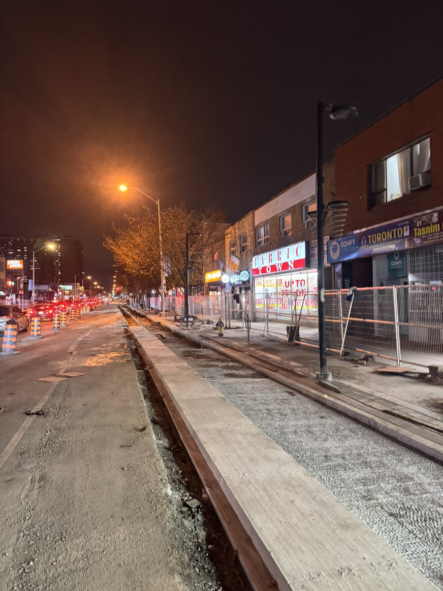 redvineski's tweet photo. Haven’t seen anyone mention it but tonight I noticed bike lanes are being installed along the Danforth near Main and Victoria Park. They look great and permanent with a large cement curb. Very similar strip to what’s being removed by Doug Ford near Royal York. https://t.co/0HIAULqn4A