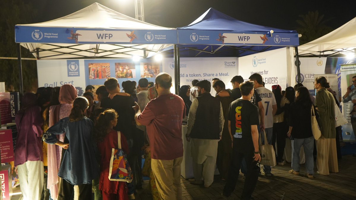 WFPPakistan's tweet photo. What a day, Karachi!🩵UN Day brought people  together for a celebration of learning, laughter and hope. At the WFP stall, visitors shared messages for schoolchildren, took on fun challenges, and explored how our work is building brighter futures across Pakistan https://t.co/kUmg9OTuMs
