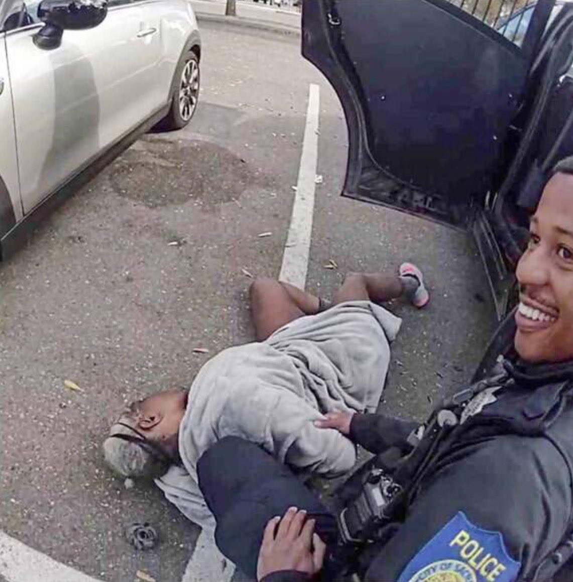 captivatedbyBlk's tweet photo. 🔴Lawsuit photos show California officer smiling over a handcuffed woman, 66, who later died

🔺A lot of Black cops strive to be accepted by white cops and would d anything to prove themselves like good little boys and girls expecting a treat https://t.co/5m1XDyle09