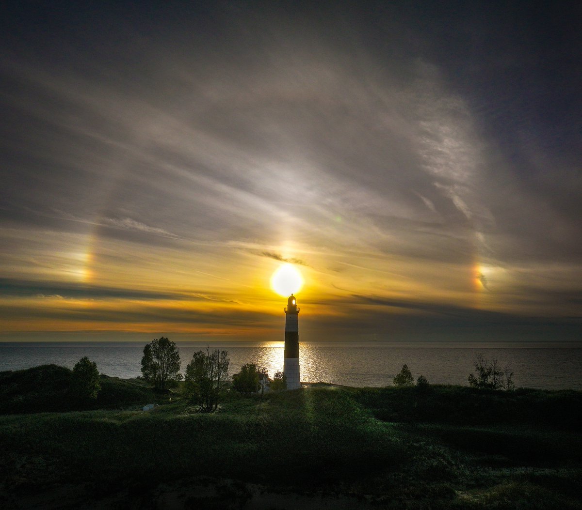 openshutter21's tweet photo. After I took the picture Ryder being a sundog in front of a sundog, I quickly took the drone off and lined up the lighthouse with it. https://t.co/aSh7uAoAE0