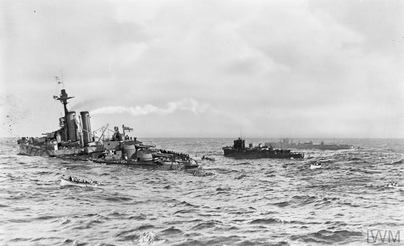 HiddenHistoryYT's tweet photo. Oct 27, 1914. One of Britain's newest battleships sinks off Ireland. The government spends the next four years pretending it never happened.

HMS Audacious was barely a year old. A modern dreadnought with ten 13.5-inch guns, one of the most powerful warships in the world.

On the morning of Oct 27, 1914, she left Lough Swilly on the north coast of Ireland with the rest of her squadron for gunnery practice. At 8:45 a.m., in the middle of a turn, there was an explosion under her port side.

She had hit a mine. It had been laid just days earlier by Berlin, a German passenger liner converted into a minelayer.

The damage didn't look fatal at first. But the blast had hit a part of the ship with no protective bulkhead, and the water spread slowly from compartment to compartment. She began to settle by the stern.

Admiral Jellicoe, commander of the Grand Fleet, was afraid of U-boats in the area. He wouldn't risk sending other battleships to tow her.

Help came from somewhere unexpected. The liner RMS Olympic, sister ship of the Titanic, was passing by on her way from New York. Her captain offered to tow the battleship.

A line was passed and Olympic started pulling. But Audacious was flooded and impossible to steer, and the line snapped. A cruiser and a coal ship tried too. Every line broke.

By evening, the crew had been taken off. Around 9 p.m., Audacious rolled over and blew up. A piece of armor plate flew hundreds of yards and killed a sailor on a nearby cruiser. He was the only death.

Now came the strange part.

Jellicoe begged the Admiralty to keep the loss secret. Britain's lead over the German fleet in modern battleships was small, and he didn't want Germany to know it had just gotten smaller.

But Olympic was full of passengers, many of them American. They had watched the whole thing. Some took photos. At least one shot film.

So Olympic was held at Lough Swilly and the passengers were kept from contacting anyone. It didn't work. Photos ended up in American newspapers within weeks.

The British government still refused to admit it. Audacious stayed on the official list of ships.

The loss was finally announced on Nov 14, 1918. Three days after the war ended.