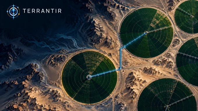 Conceptual overhead view of Saudi Arabian desert agriculture, with green center-pivot fields and sandy terrain. A cyan conduit motif links two field centers and a gold ring highlights one field. Illustrative water-use context, not measured withdrawals or an actual site map. Official TERRANTIR orbital logo and wordmark at upper left.