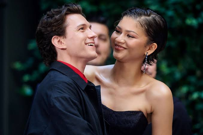 Mechthild_Dd's tweet photo. Nah this is wild. Timothée and Zendaya look cute or whatever but Tom is literally her husband. A “scripted kiss” on the red carpet is still a kiss in front of the whole world. 

Imagine your girl locking lips with her co-star while you’re sitting at home. 

The way they’re gripping each other in that first pic is crazy. Zendaya always says the right PR thing but actions > words. 

Tom’s probably somewhere stressing and everyone just laughing it off because “it’s for the movie.” 

I get they have to promote Dune 3 but this feels messy. Hope Tom is good.