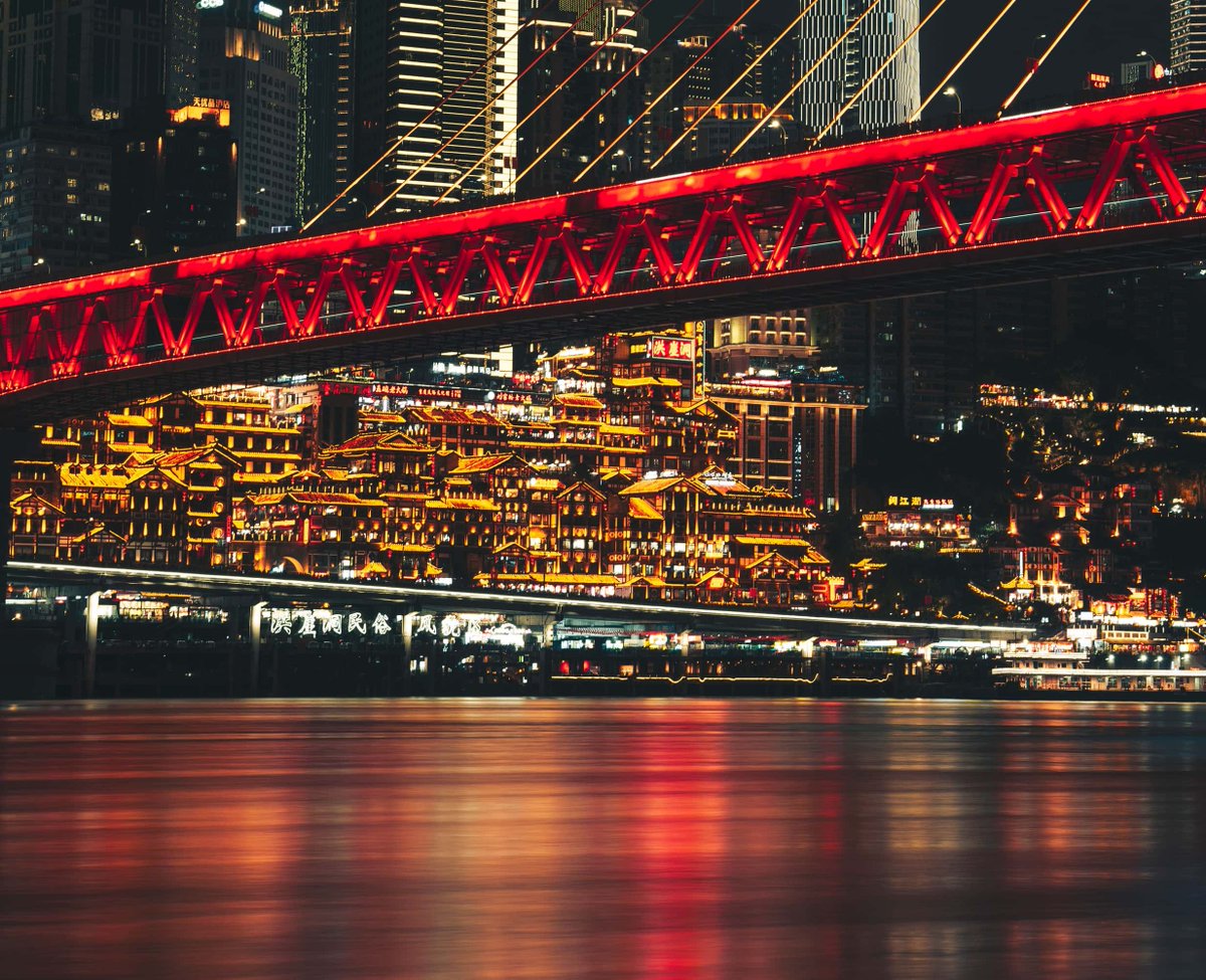 gracdxelylpoo's tweet photo. City lights glowing on the water, a red bridge overhead, and glowing old rooftops below. The perfect night for a slow wander. #CityNights #NightWalk #Travel https://t.co/w7AUXdgm6x
