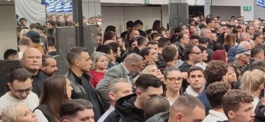 ChristosGalani1's tweet photo. Ενημερωτικά, επειδή γίνεται μεγάλο σούσουρο στα σόσιαλ, οι φωτογραφίες του Κασιδιάρη με το "πολυπληθές" νεανικό κοινό παρουσιάζουν οπτικά "σφάλματα" γεωμετρίας. Είναι σχεδόν βέβαιο το μοντάζ ή επεξεργασία με AI.

1. Ο Κασιδιάρης εμφανίζεται αισθητά καθαρότερος από το πλήθος, με διαφορετική ευκρίνεια και απόδοση λεπτομερειών.

2. Ο άνδρας με το τζόκεϊ στον αριστερό καθρέφτη δεν αντιστοιχεί σε κανένα πρόσωπο που διακρίνεται στο ορατό κοινό.

3. Η τεράστια ελληνική σημαία με τον μεγάλο σταυρό στον πρώτο αριστερά ψηλότερο καθρέφτη δεν υπάρχει πουθενά στο βάθος της αίθουσας ώστε να αντικατοπτριστεί στον φωτογράφο. Είναι αντίγραφο της απέναντι που δεν μπορεί να ανακλαστεί στον φωτογράφο. 

4. Οι τρεις διαδοχικοί στενοί καθρέφτες στα αριστερά δίπλα ακριβώς από τον ψηλότερο, που εμφανίζουν πανομοιότυπες σημαίες και κεφάλια, είναι καθαρό μοντάζ cloning.

5. Το φαινόμενο βάθος και η πυκνότητα του πλήθους δεν φαίνονται να συμβαδίζουν με τις διαστάσεις της αίθουσας. Ο κόσμος μοιάζει να εκτείνεται σε πολύ μεγαλύτερο χώρο από τον πραγματικό.

6. Το ChatGPT αρχικά δεν εντόπισε αυτά τα σφάλματα (αντίθετα με άλλες φορές που εντοπίζει fake φωτογραφίες), και αναθεώρησε την εκτίμησή του όταν του απέδειξα τα συγκεκριμένα σημεία.