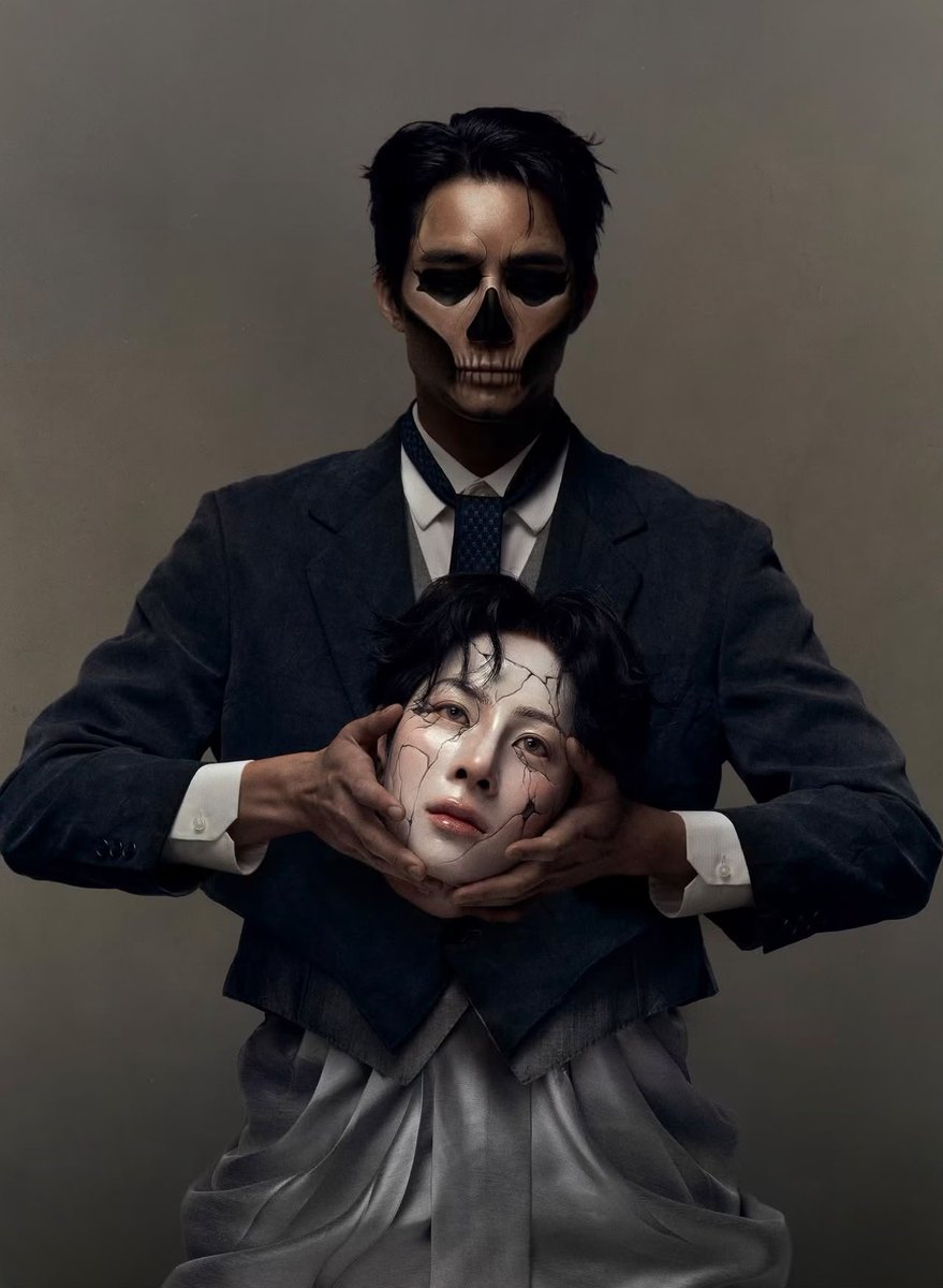emeuof's tweet photo. Death and a broken porcelain doll. One dressed in a dark, immaculate suit, face transformed into a chilling skull. The other, pale and fragile, with delicate cracks spreading across porcelain skin. Death cradles the doll’s face is both unsettling and strangely tender. #EarthMix https://t.co/QmOhK4iQw8