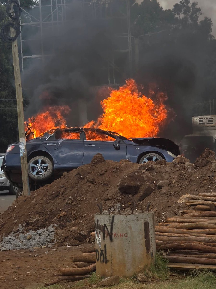 ClintonObonyo's tweet photo. Near Talanta Stadium, Kenol Stage this morning — a speeding car flew off the road, over the pavement and into a mound. A lady waiting for a Ngong matatu was hit unaware. Her arm was severed. She died on the spot. The front passenger never even blinked. Gone too.
The driver was drunk. He stumbled out of the wreck still holding a bottle. Two more bottles were found. Two other passengers were rushed to hospital injured.
How many times will we keep saying “it was just one drink”? How many innocent people waiting by the roadside must pay for someone else’s recklessness? When do we finally stay alert — every single time?