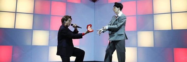 namgi kiss on stage at bts world tour banner