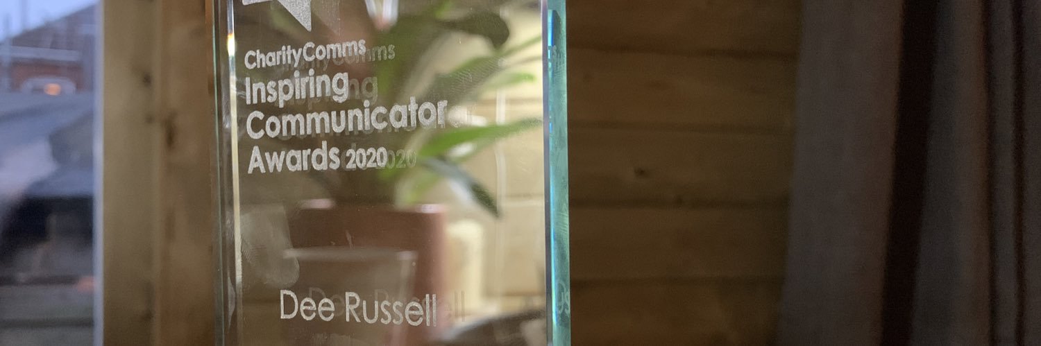 Dee Russell (they / she) 💗💛💙 banner