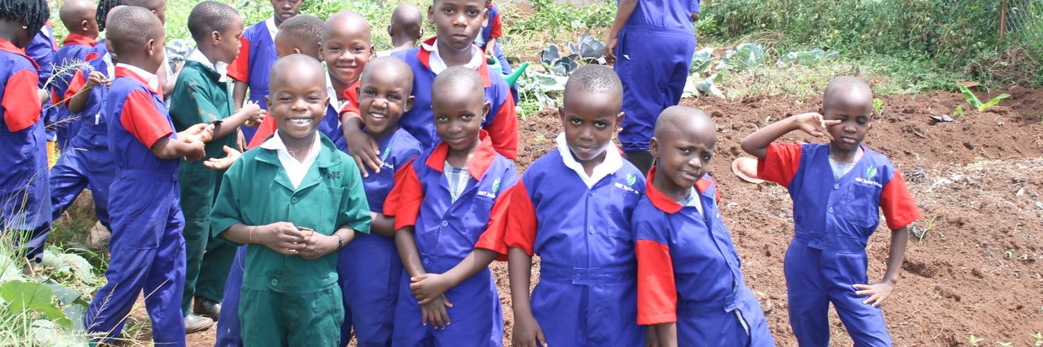 Quality Education@MST Jr Sch. with Dr.Naluyima's banner
