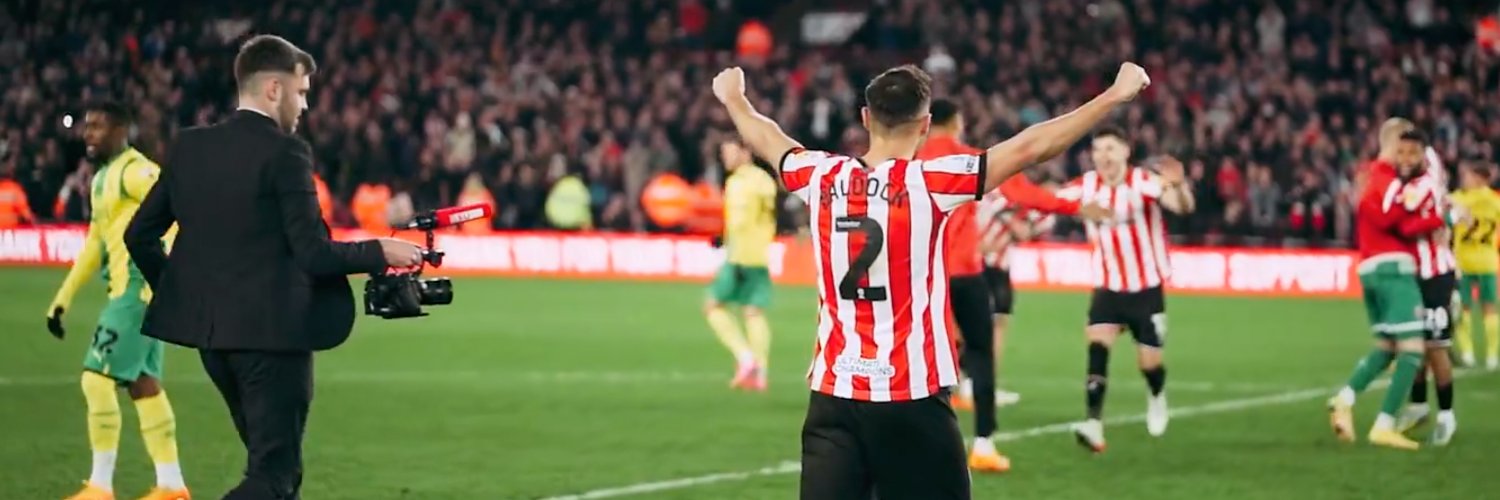Attacking Football's banner