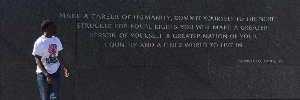 Minister Dominique Alexander's banner