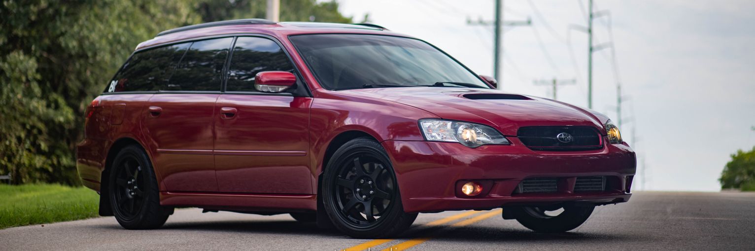 Red Subaru Legacy banner