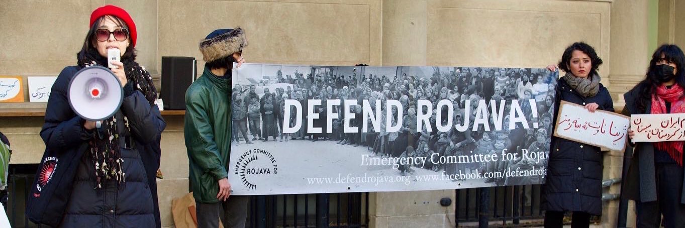 Emergency Committee for Rojava's banner