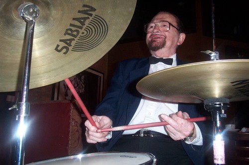 musician hitting the high hat and whacking the bass drum