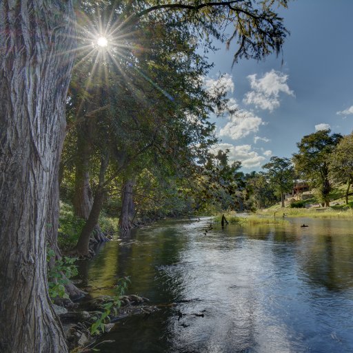 Enjoy this private waterfront retreat on a tranquil strip of the Guadalupe River with endless Hill Country views.