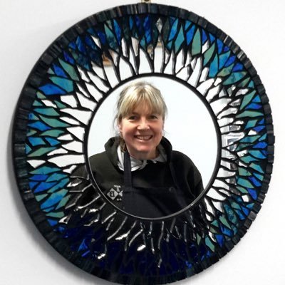 Mosaic artist at Cockington Court, Torquay, Devon. Creating unique handmade mosaic items such as mirrors and pictures.