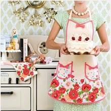 This girl likes wearing pink aprons and playing in the kitchen.