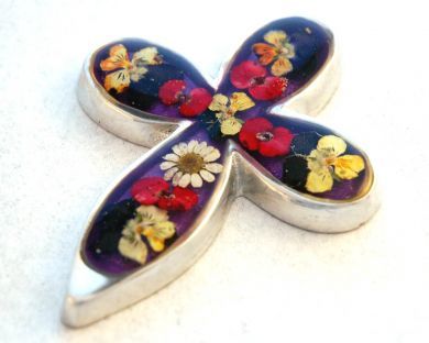 Our unique and original crosses, art, and jewelry are made with real miniature flowers, sealed in resin, on a base of pewter or silver.