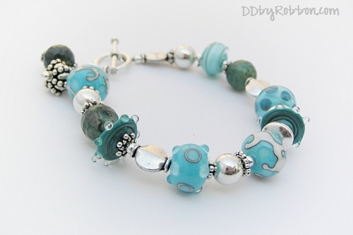 Lampwork artist, jewelry designer, mom of two and love to tinker to make things pretty in my home and in life.