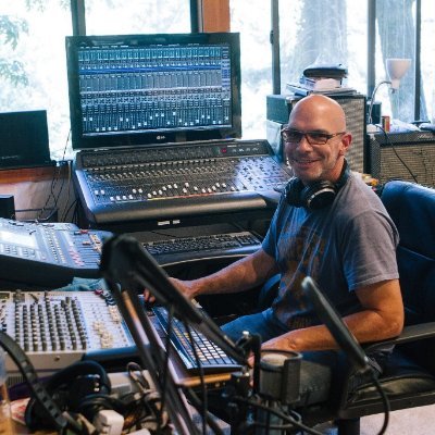 A musician on a ranch with a tour bus