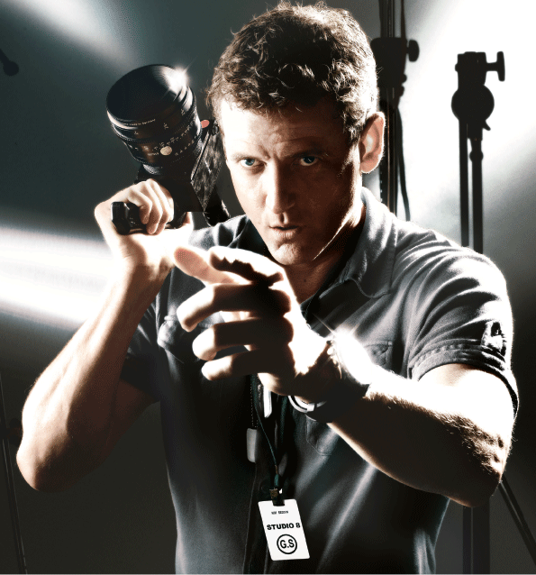 KimReddin's profile picture. Stands next to cameras.