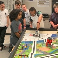 Group of high schoolers shining in our ABILITIES, breaking barriers, and hoping to inspire others through our participation in FIRST LEGO League.