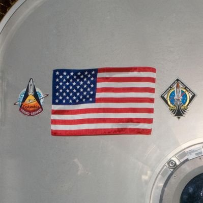 A flag was left on the ISS from the last Space Shuttle mission. It will be returned to the ground once America has restored it's crew launching capability.