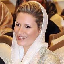 I'm Ayesha Gaddafi, also known as Aicha Al-Kadhafi, as a former Libyan mediator and military official, former UN Goodwill Ambassador, and lawyer by profession